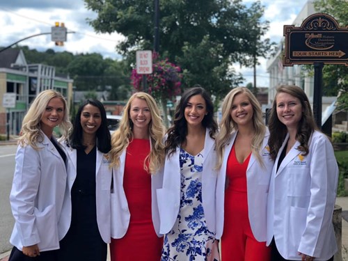 Brooke Dolin (second from right) poses with some of her classmates at their White Coat ceremony.