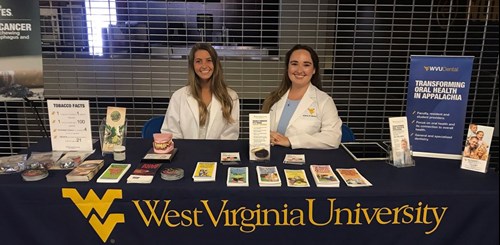 Claire Frank, dental hygiene student, and Laura Settles, DDS student, present nicotine addiction awareness.