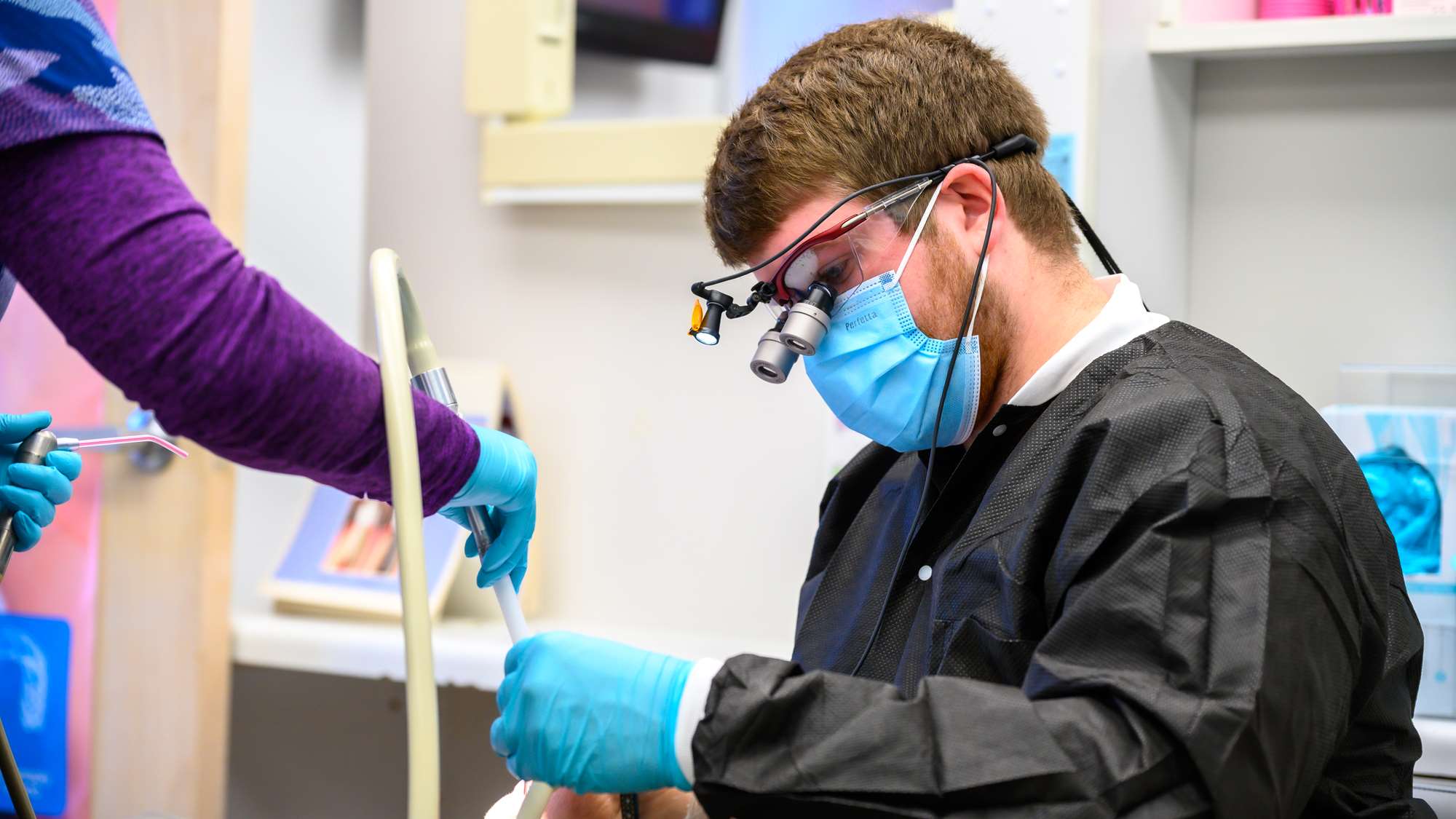 DDS student Zach Lynn treats a patient on his rural rotation at Tebay and Associates in Vienna, WV. 