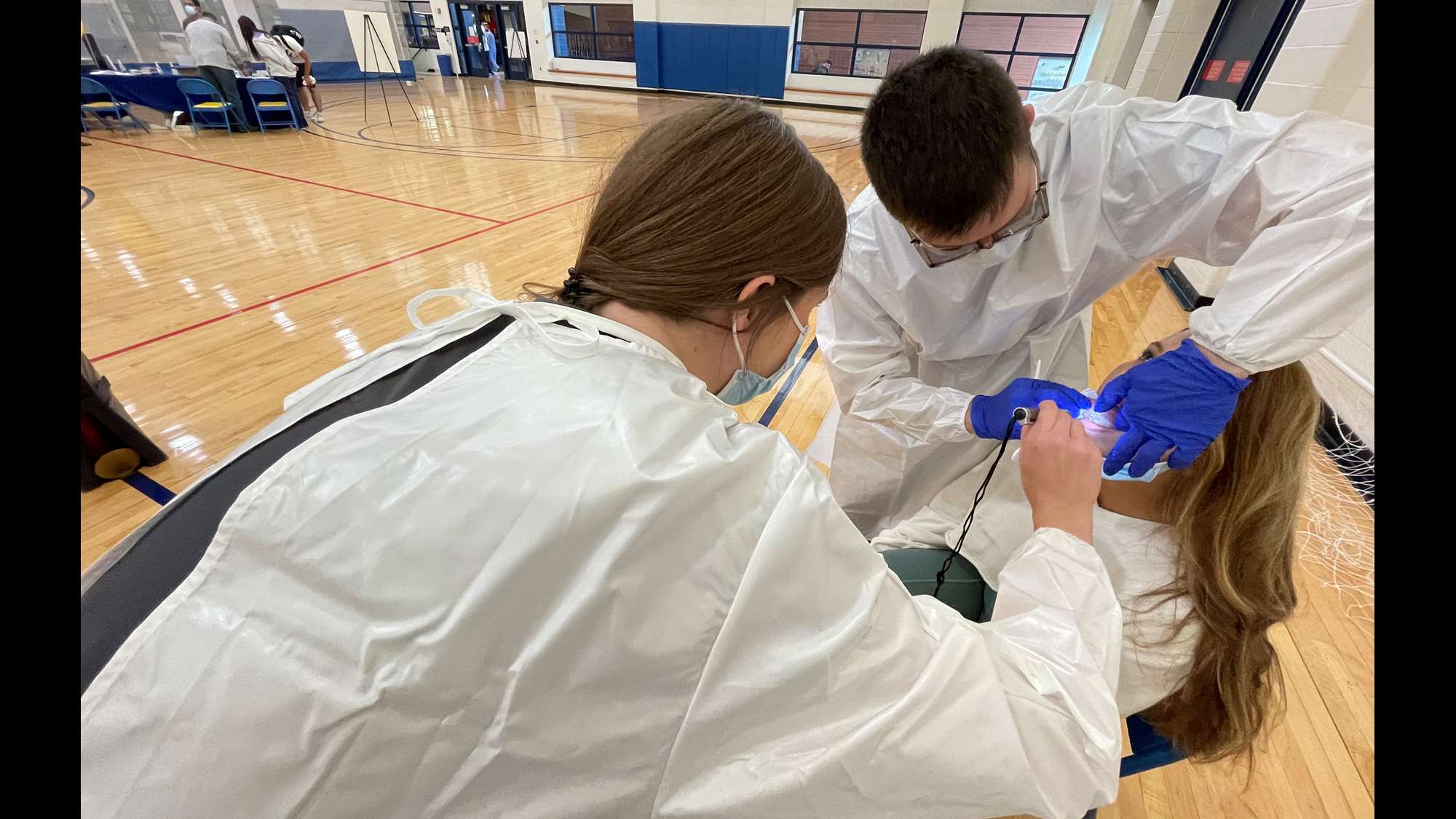 School of Dentistry students performs an oral cancer screening at an on-campus community service event. 