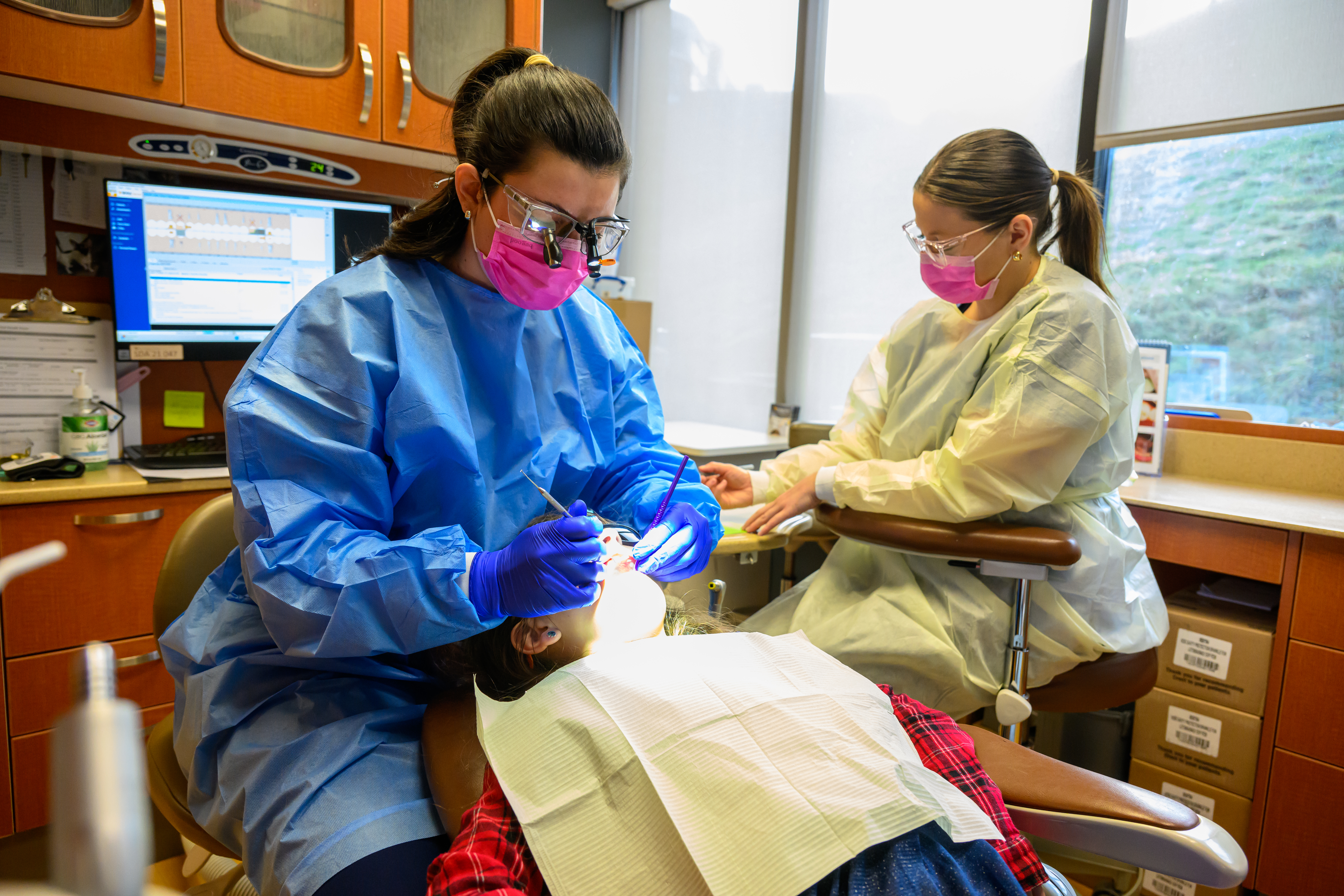 A WVU dental school student receives one-on-one instruction in a small class size.