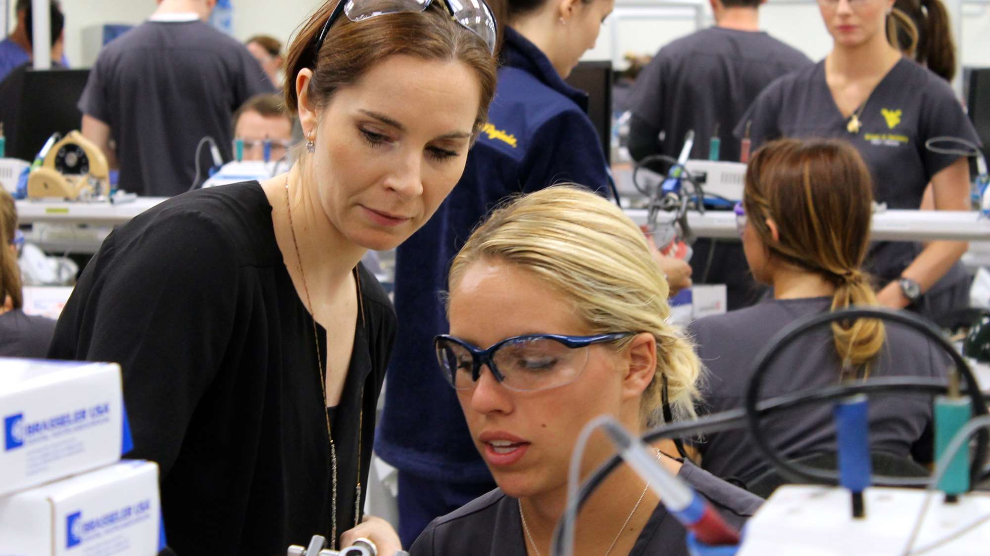 A WVU dental school student receives one-on-one instruction in a small class size.