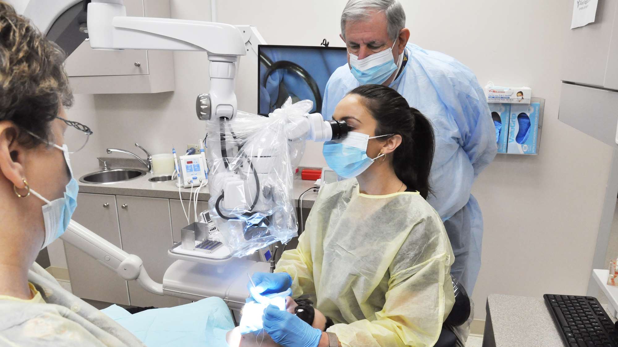 Endodontics residents treat a patient using the latest in illuminating and magnification technology.