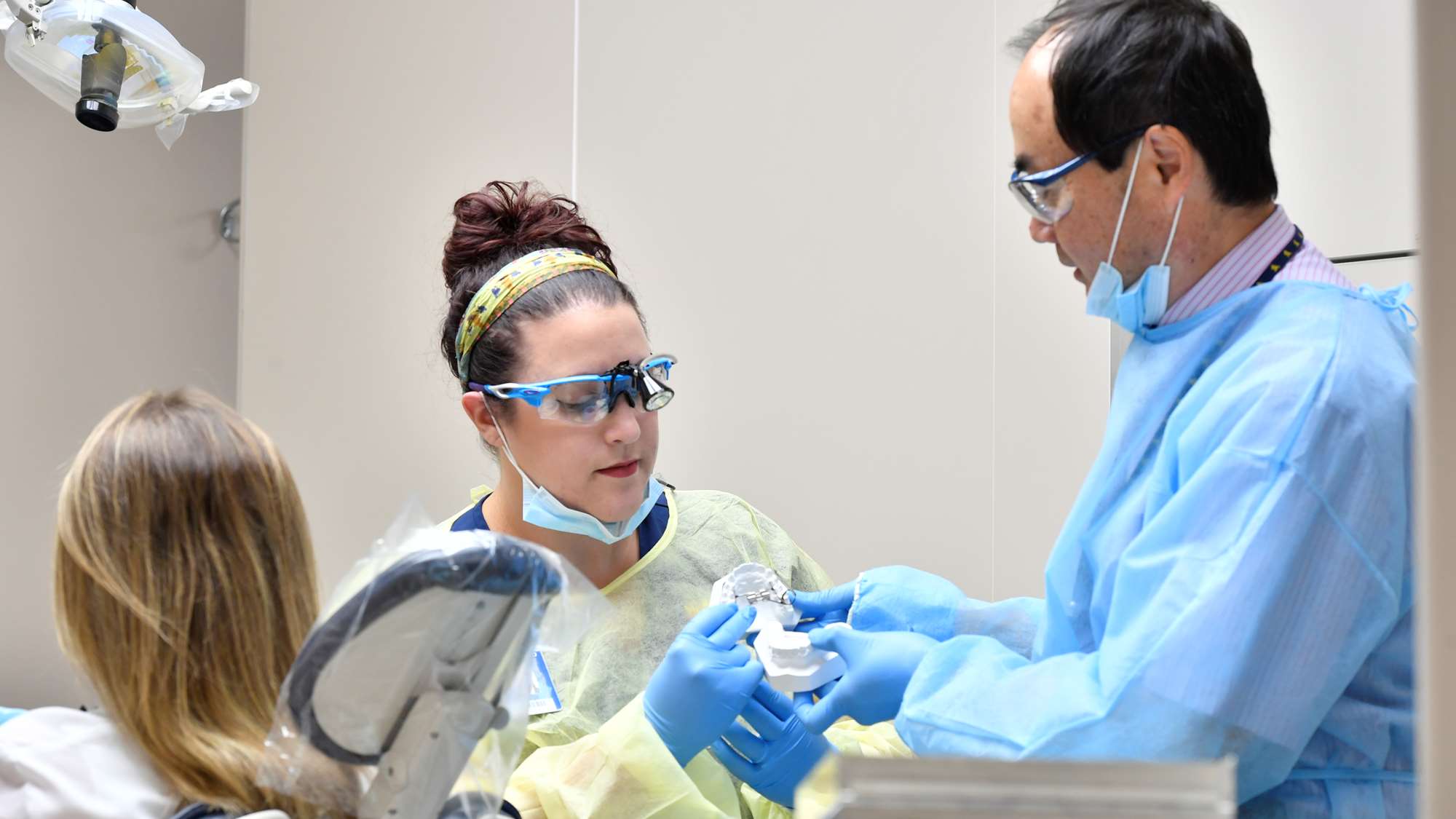 Dr. Peter Ngan instructs a former dental student.