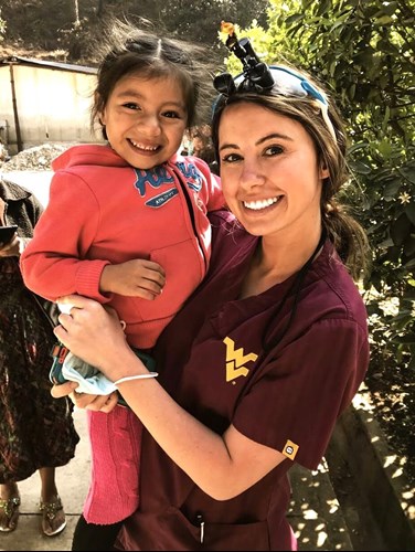 Morgan Kesecker poses with a young girl in Guatemala.