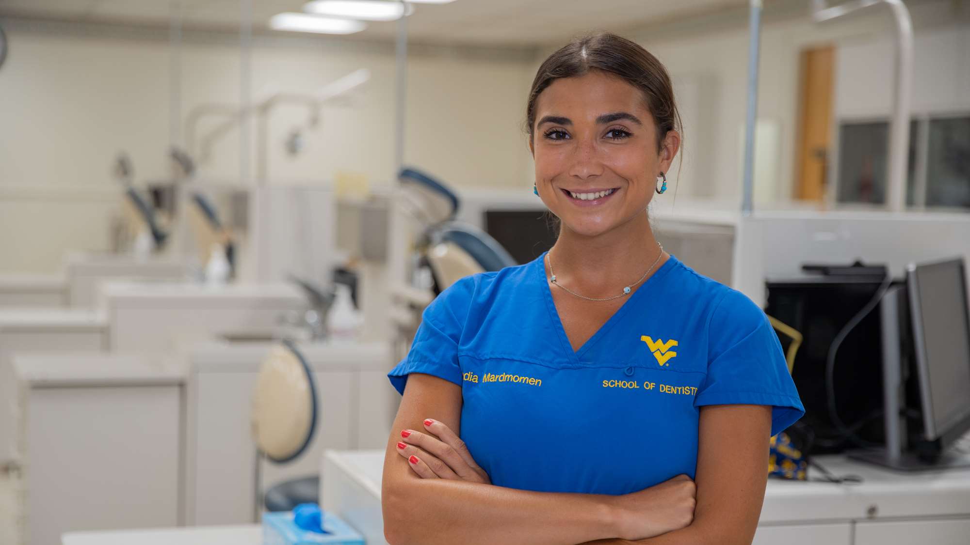 Nadia Mardmomen smiles in clinic as she talks about her path through dental school.