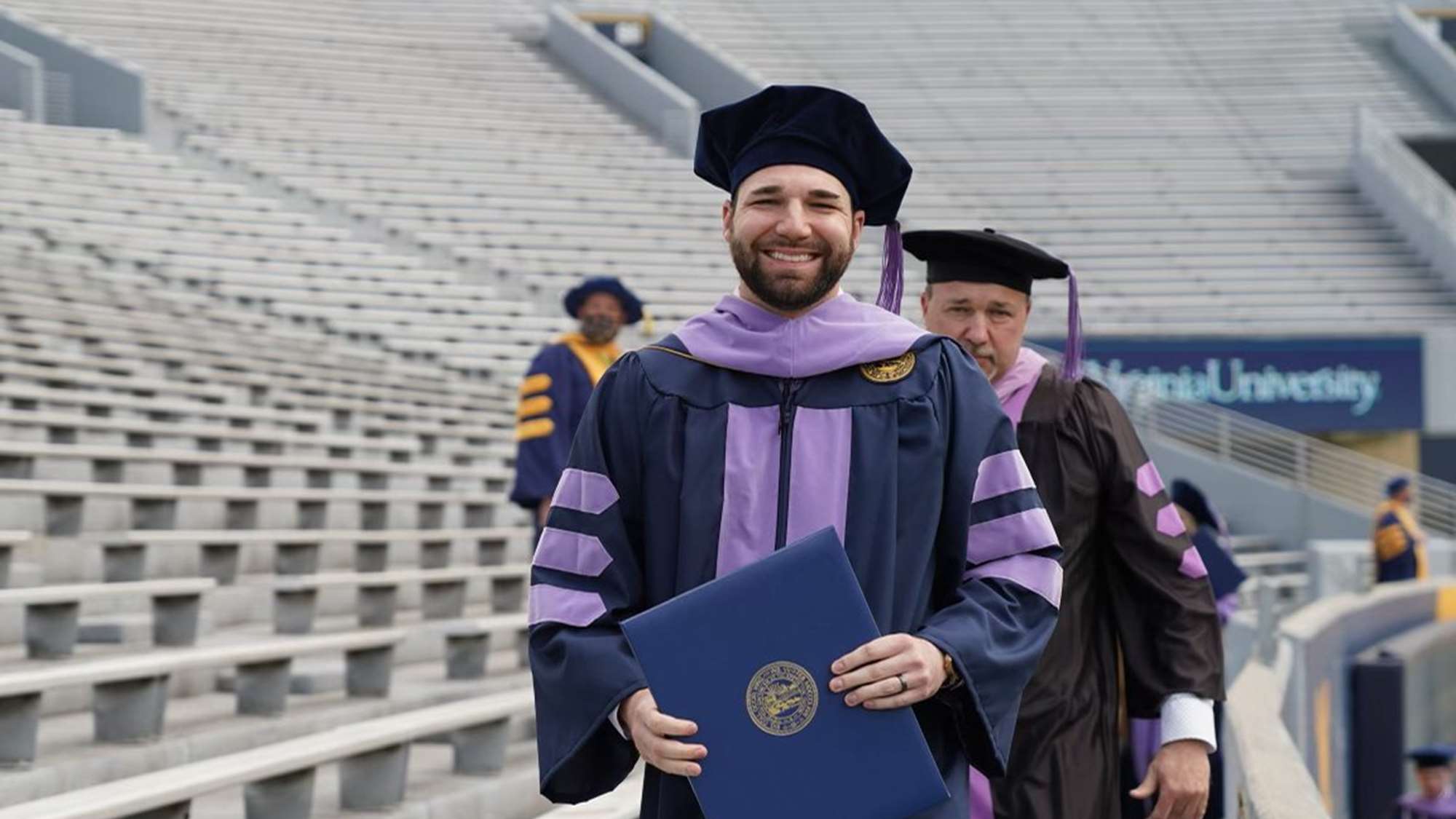 School of Dentistry graduates file into the stadium after receiving their degrees.