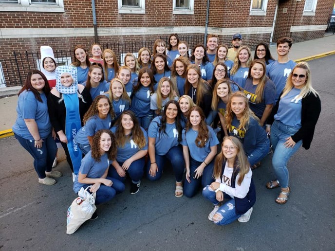 Dental hygiene students prepare to hand out oral healthcare items in the WVU homecoming parade.