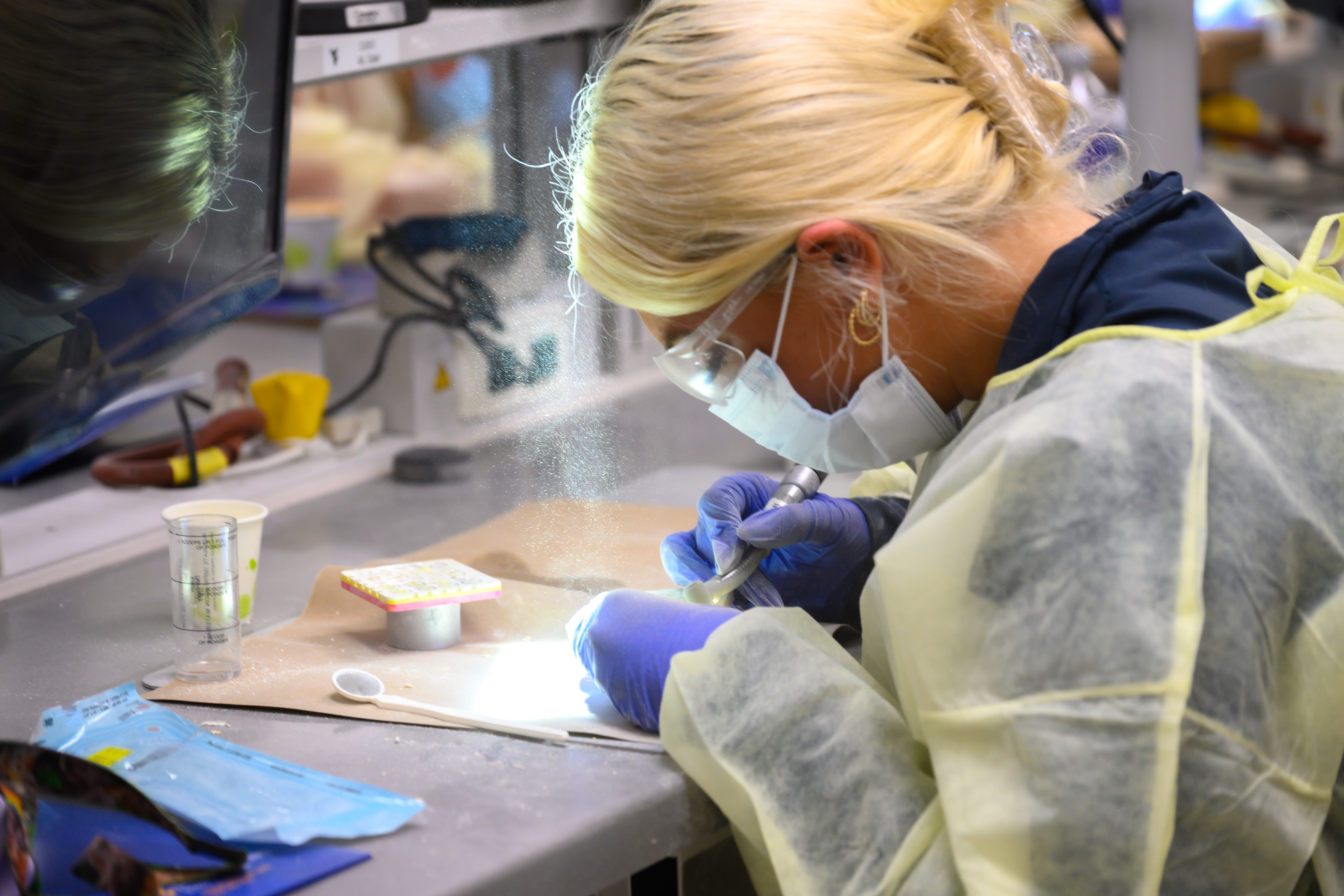 An prospective student participates in a hands-on activity in the dental simulation lab. 