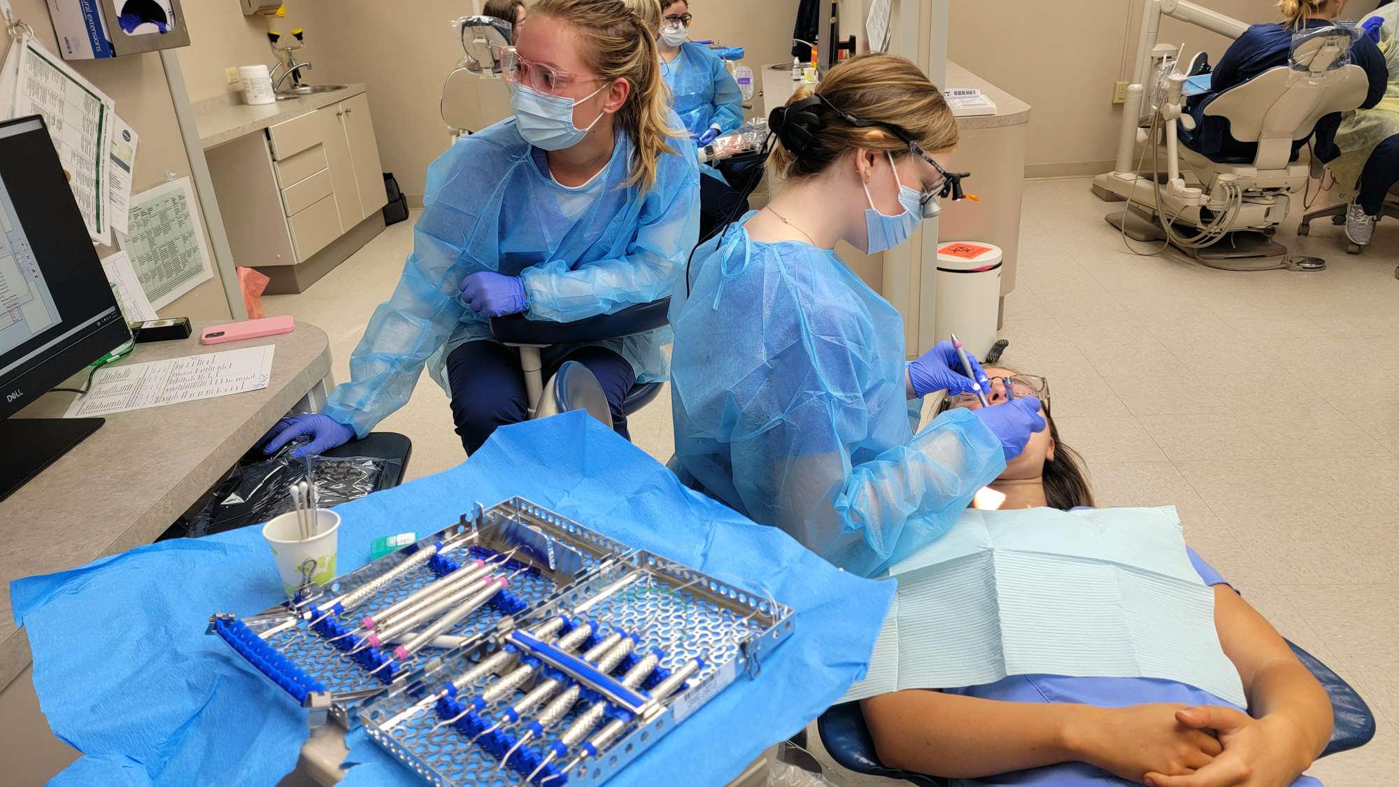 Dental hygiene students work together in an initial assessment clinic. 